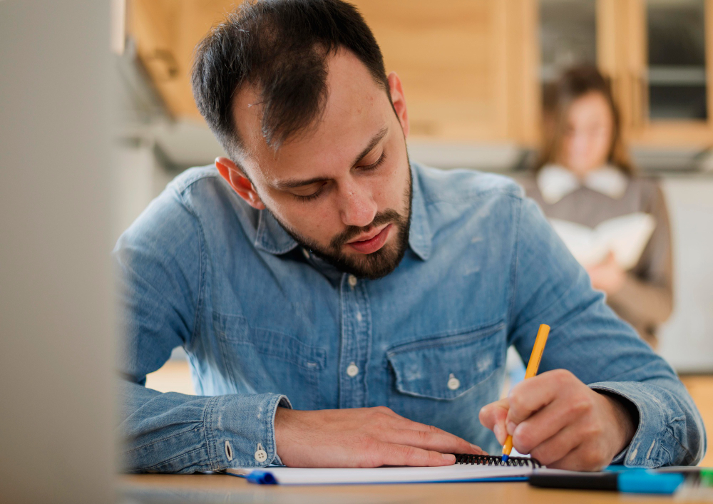 Man writing or doing a test.